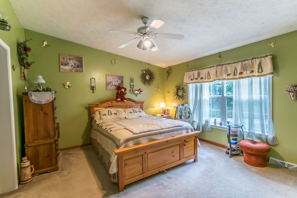 325 Steeles Fort Road Raphine, VA 24472 - Photo 37 of 50 a bed room with a bed and a chandelier