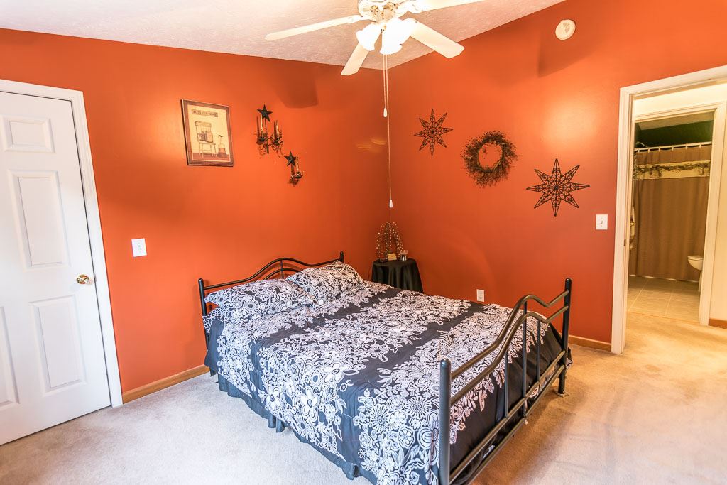 325 Steeles Fort Road Raphine, VA 24472 - Photo 42 of 50 a bedroom with a bed and a chandelier