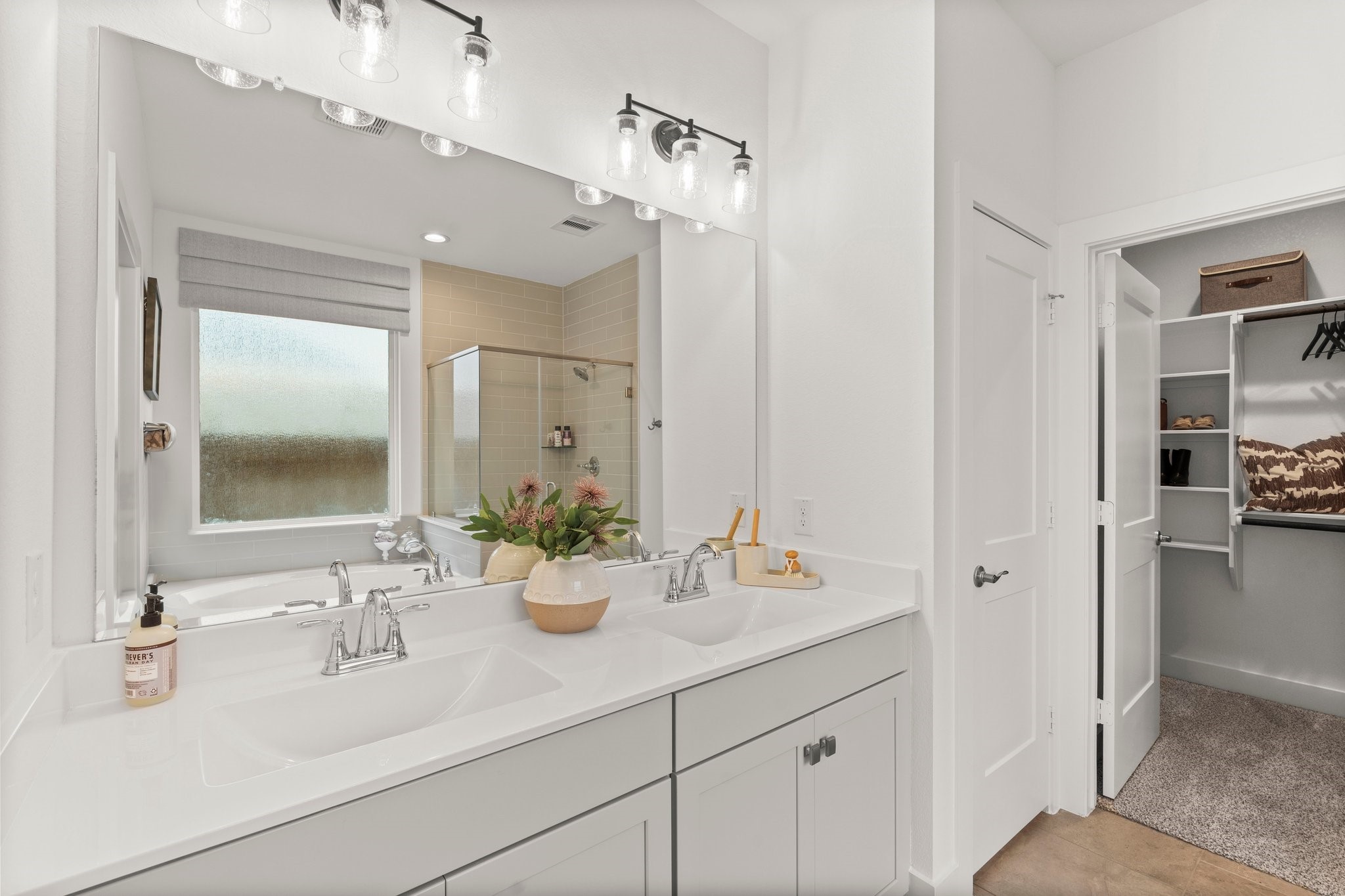 30951 Breezy Way Fulshear, TX 77423 - Photo 15 of 41 a bathroom with a sink double vanity and a mirror