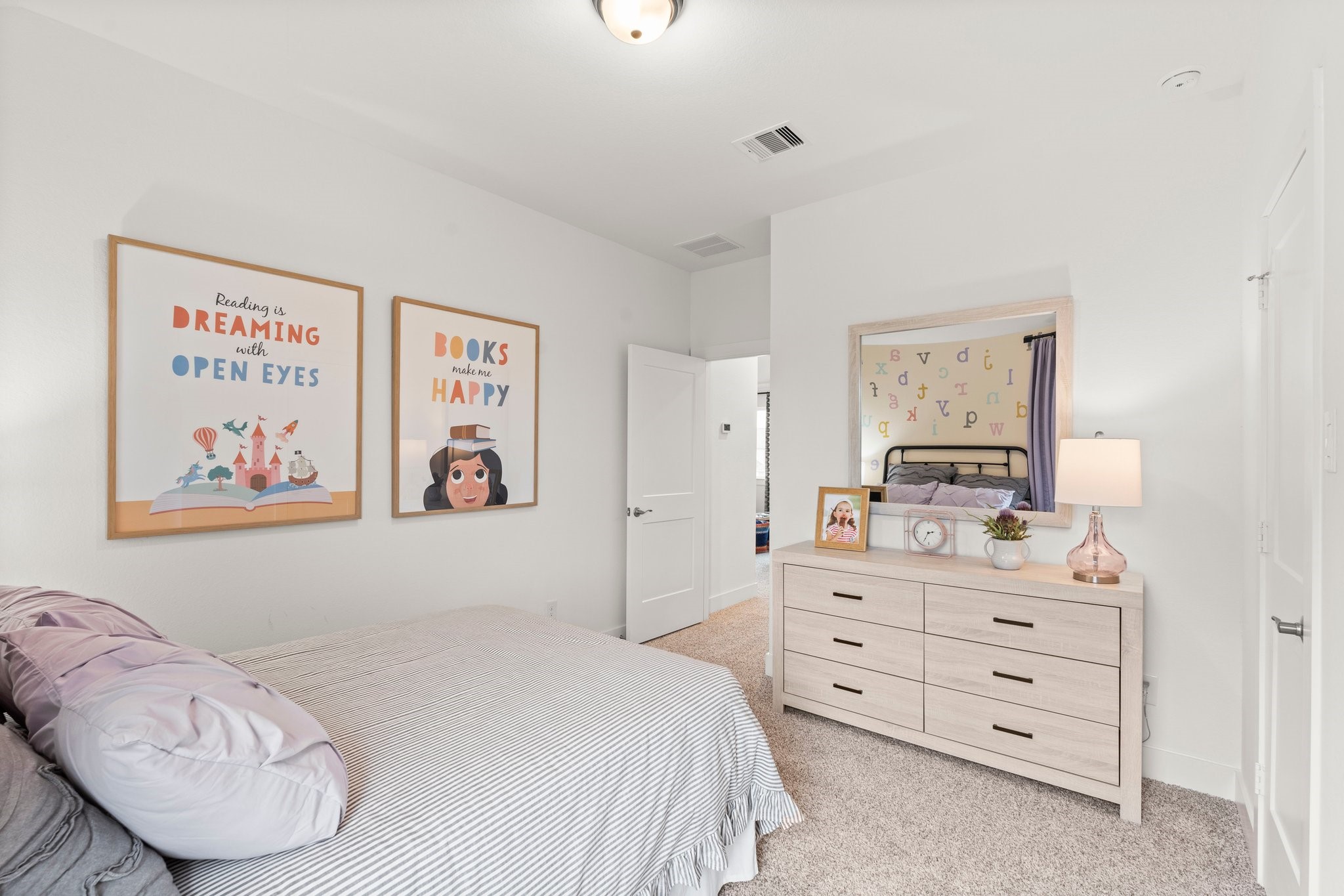 30951 Breezy Way Fulshear, TX 77423 - Photo 25 of 41 a bedroom with a bed and a dresser in it