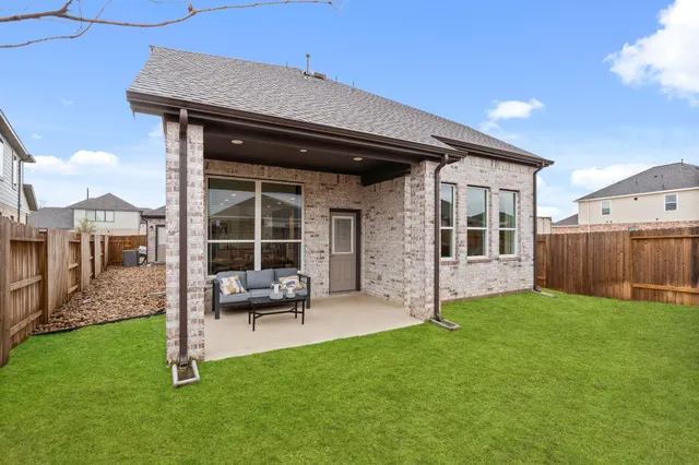 a view of a house with backyard porch and sitting area