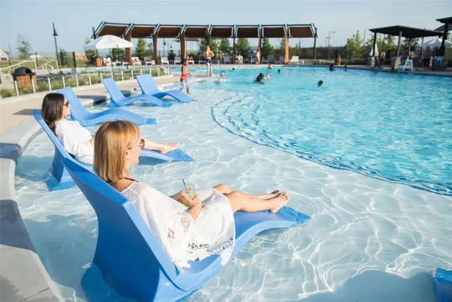 a swimming pool view with a outdoor seating space