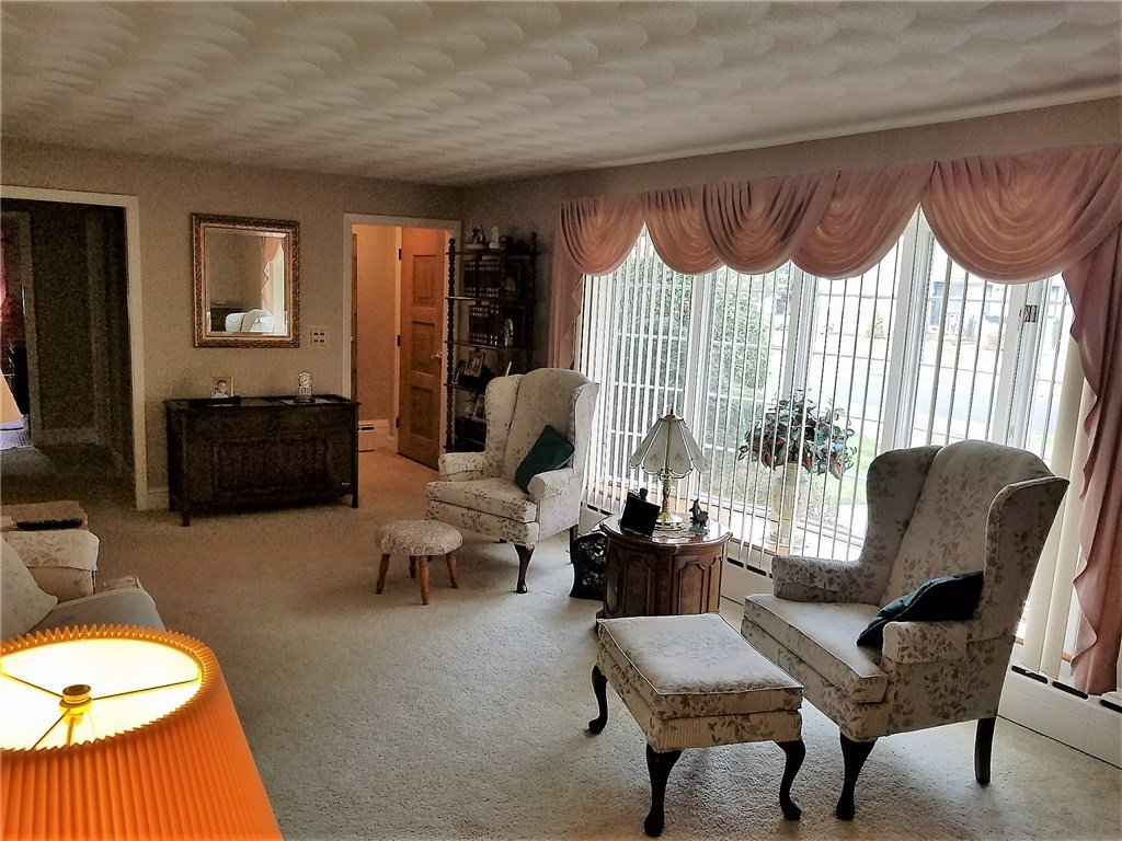 76 Park Forest Road Cranston, RI 02920 - Photo 3 of 14 Another view of the living room. Hardwood floors under the carpets. Front entry has a coat closet