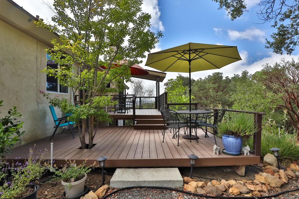 11970 Twin Springs Road Descanso, CA 91916 - Photo 1 of 1 a view of a patio with furniture and table under an umbrella