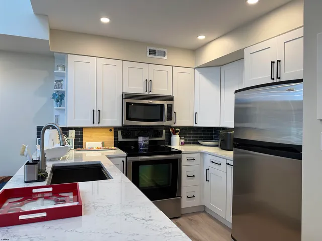 a kitchen with a sink a stove and cabinets