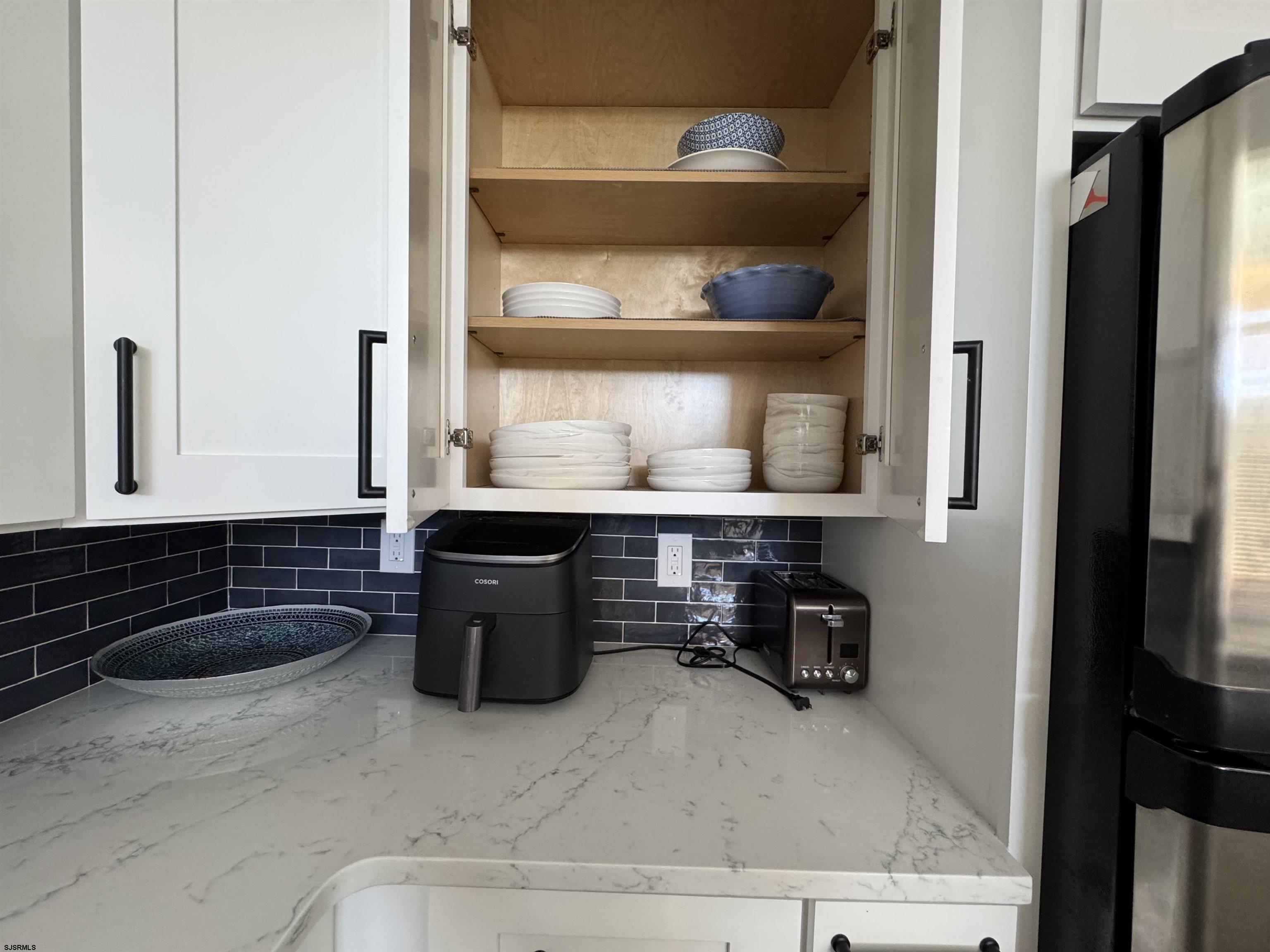9101 Atlantic Avenue, Unit 202 Margate City, NJ 08402 - Photo 12 of 26 a kitchen with a sink a stove and cabinets