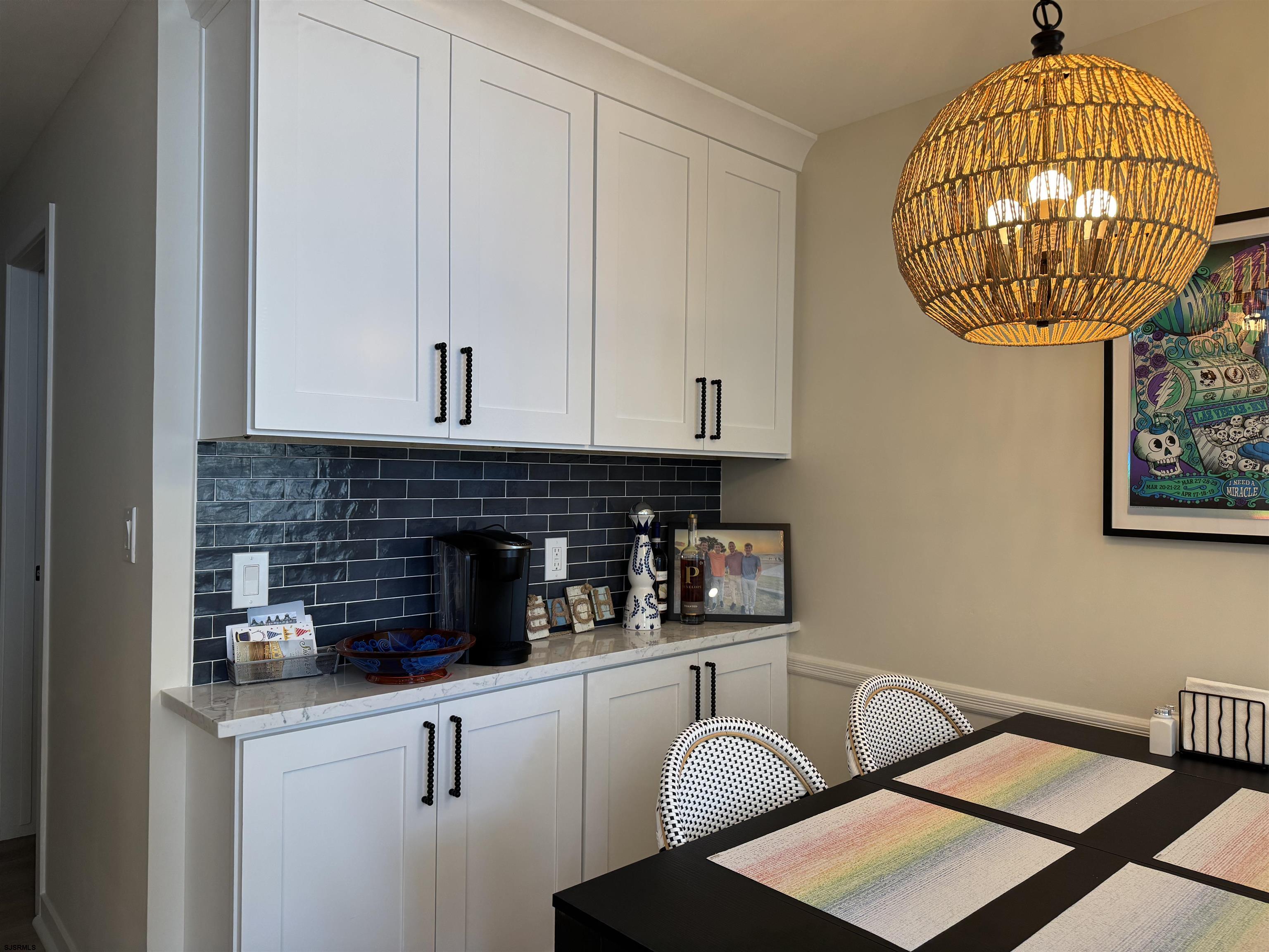 9101 Atlantic Avenue, Unit 202 Margate City, NJ 08402 - Photo 14 of 26 a kitchen with stainless steel appliances granite countertop a stove a oven a white table and chairs with wooden floor