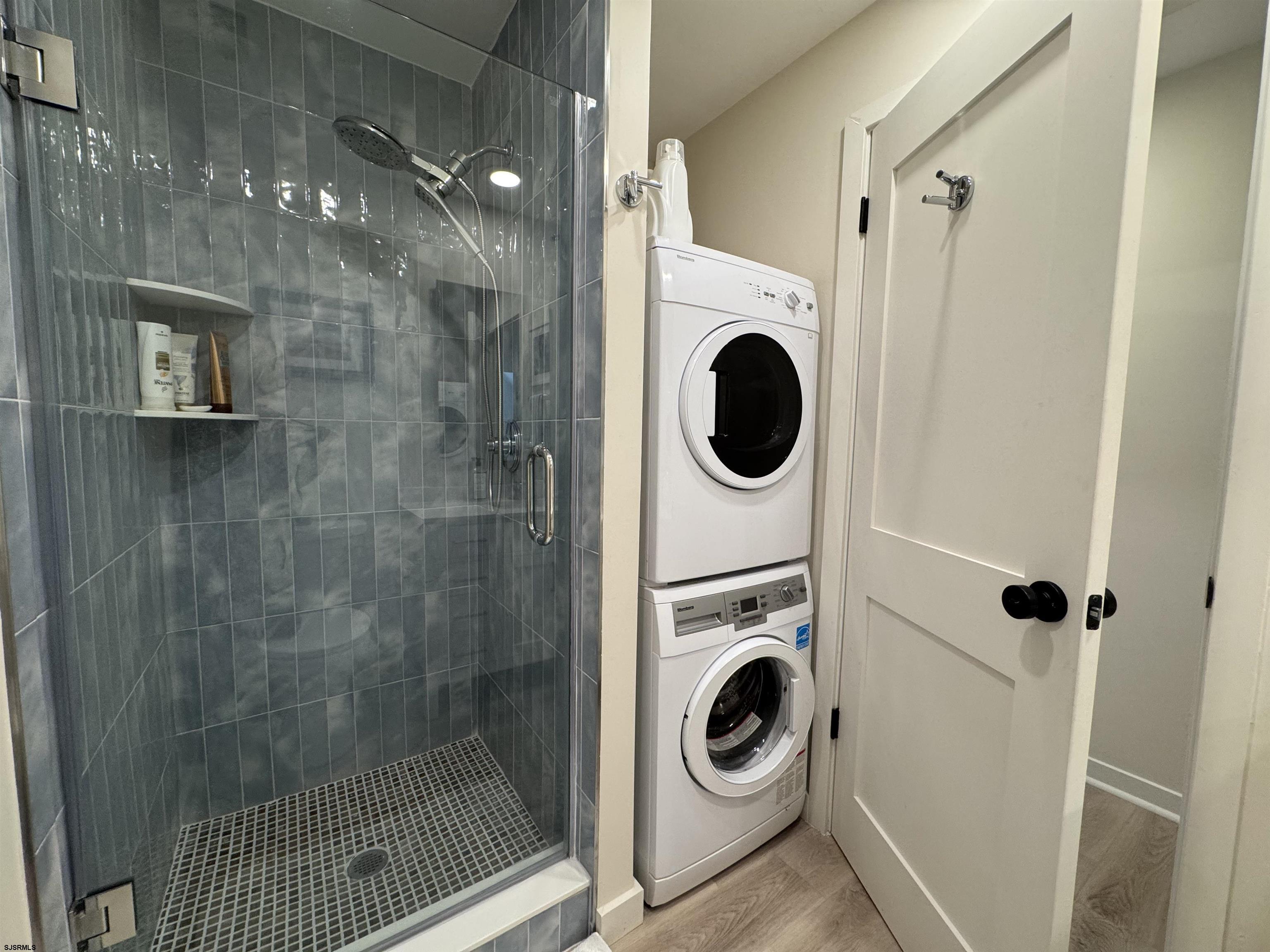 9101 Atlantic Avenue, Unit 202 Margate City, NJ 08402 - Photo 19 of 26 a view of a bathroom with a washer and dryer