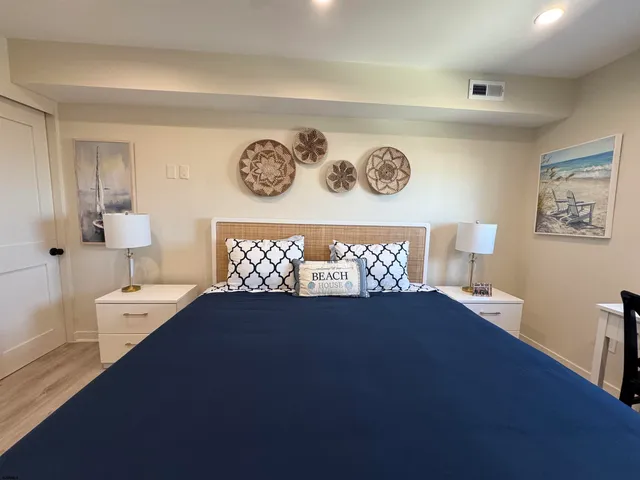 a bedroom with a large bed and a desk