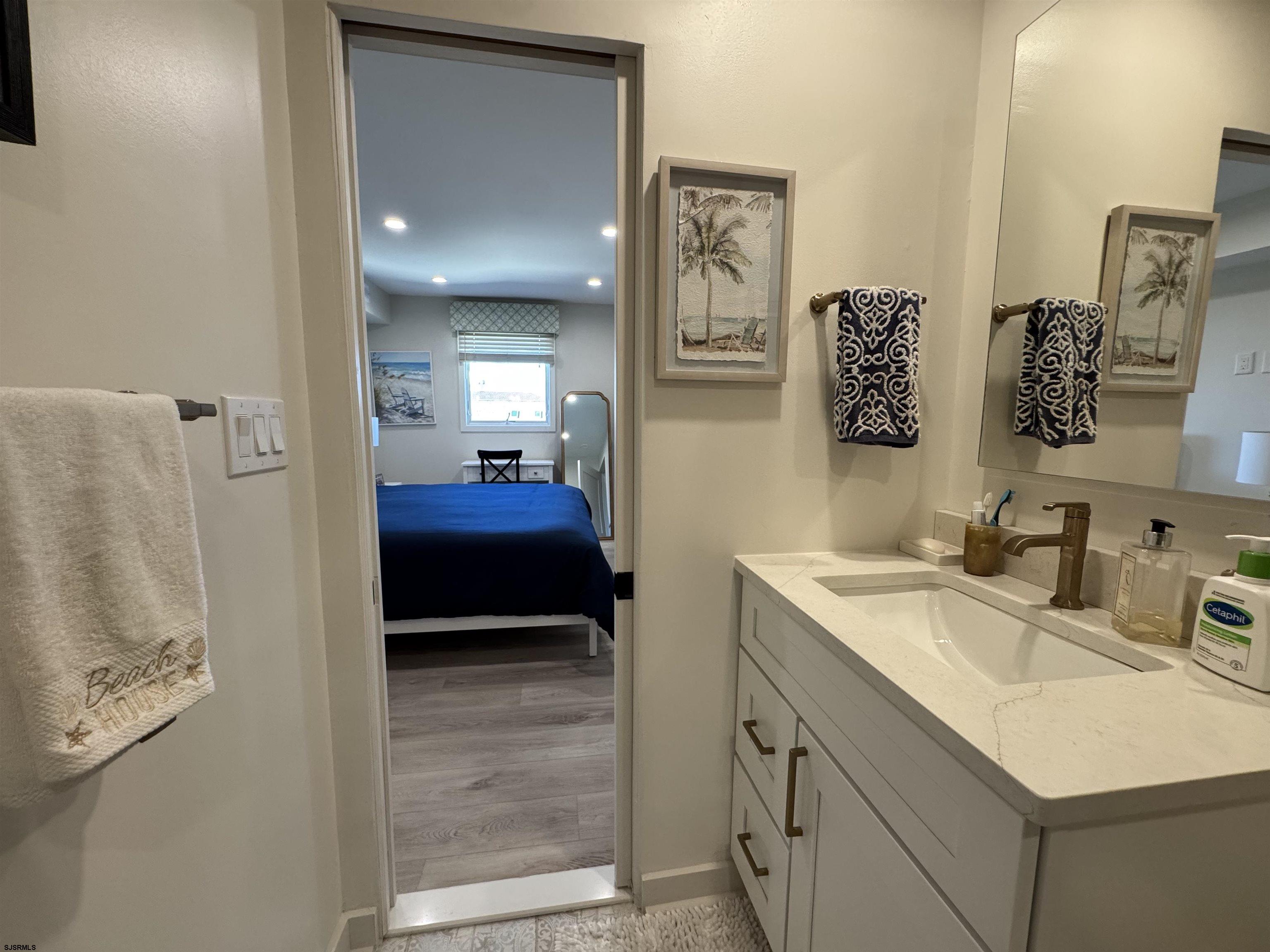 9101 Atlantic Avenue, Unit 202 Margate City, NJ 08402 - Photo 23 of 26 a en suite bathroom with a sink and a mirror