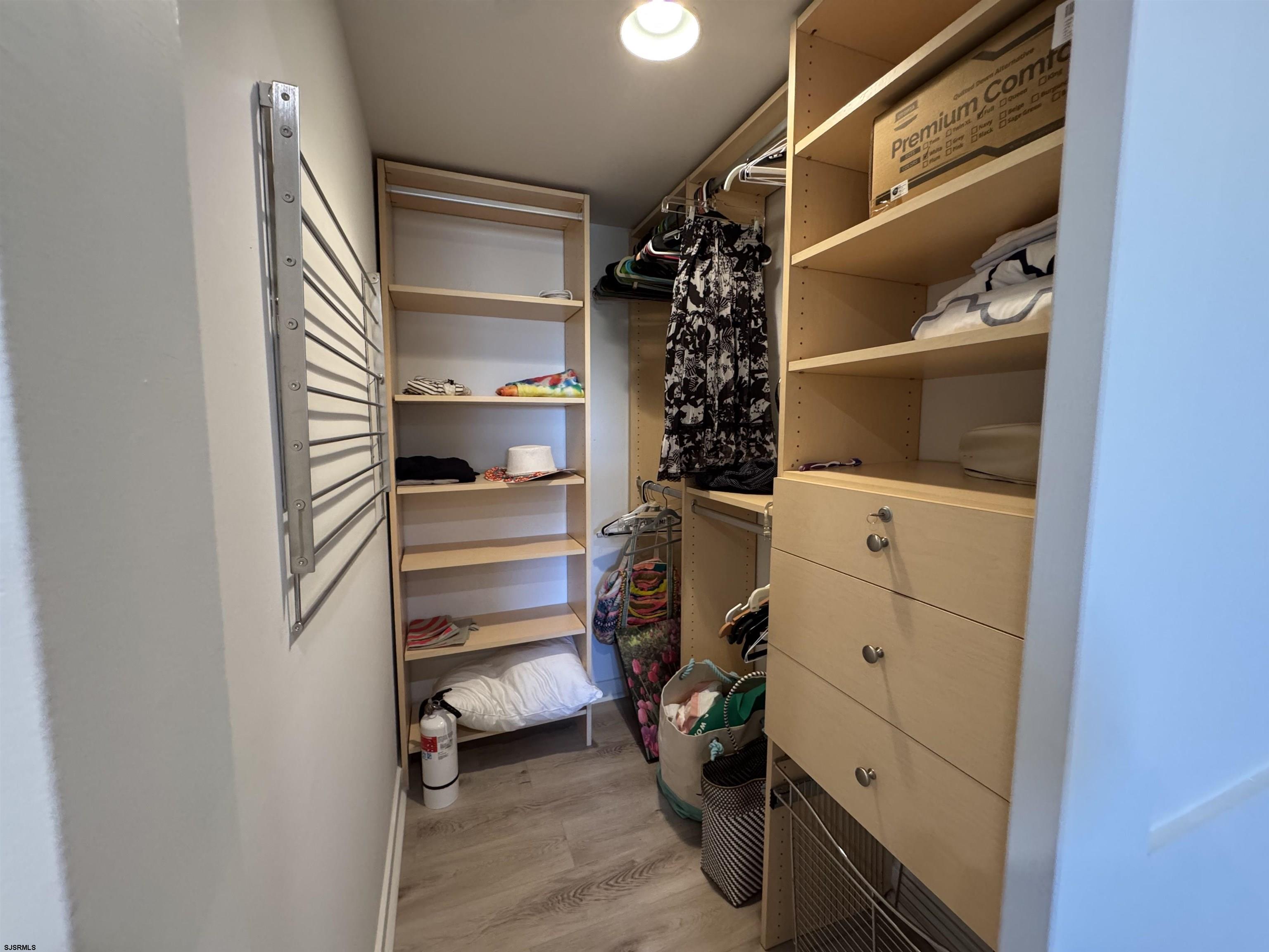 9101 Atlantic Avenue, Unit 202 Margate City, NJ 08402 - Photo 24 of 26 a view of walk in closet with clothes and shoes