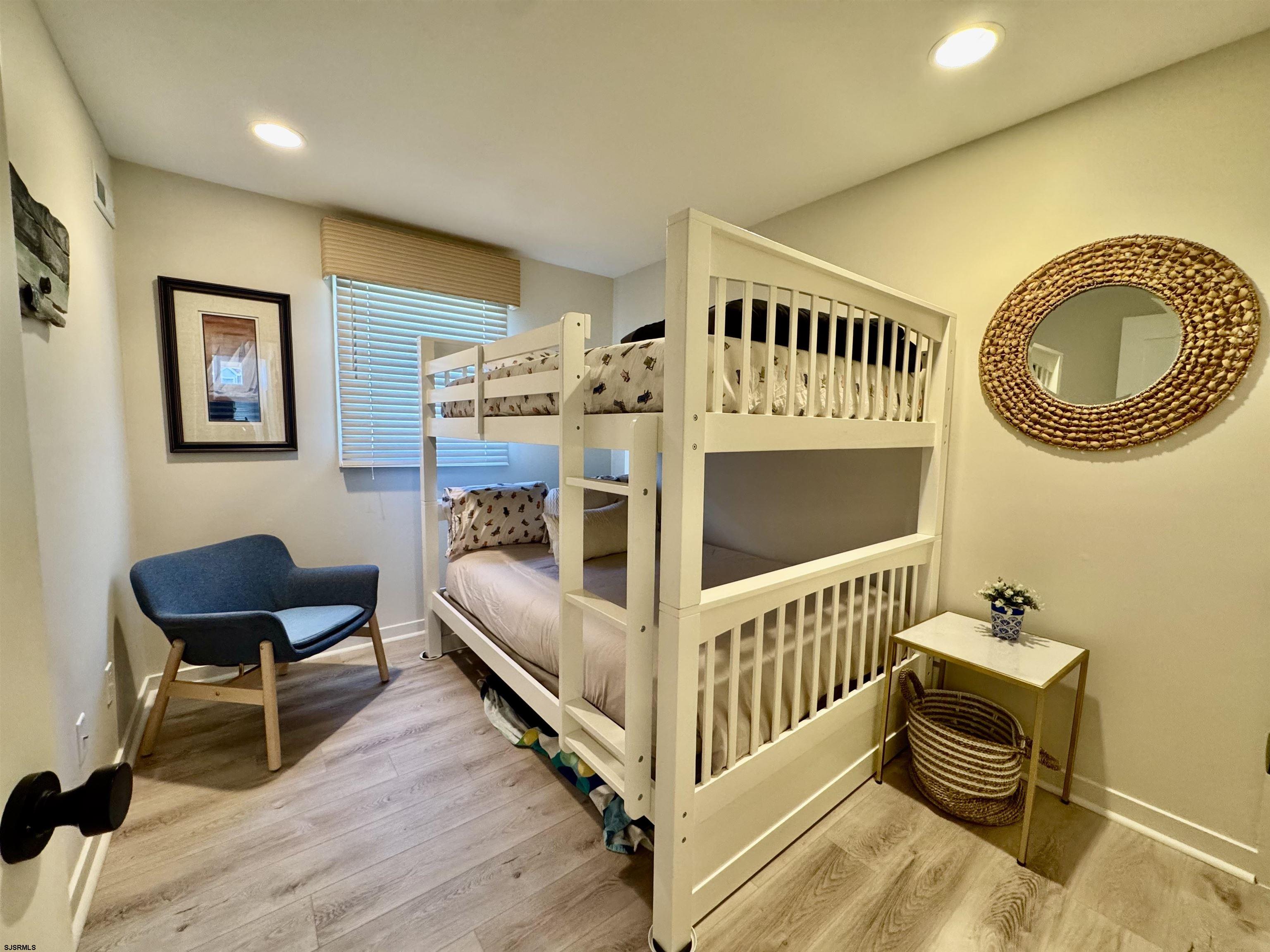 9101 Atlantic Avenue, Unit 202 Margate City, NJ 08402 - Photo 25 of 26 a bedroom with furniture and a wooden floor
