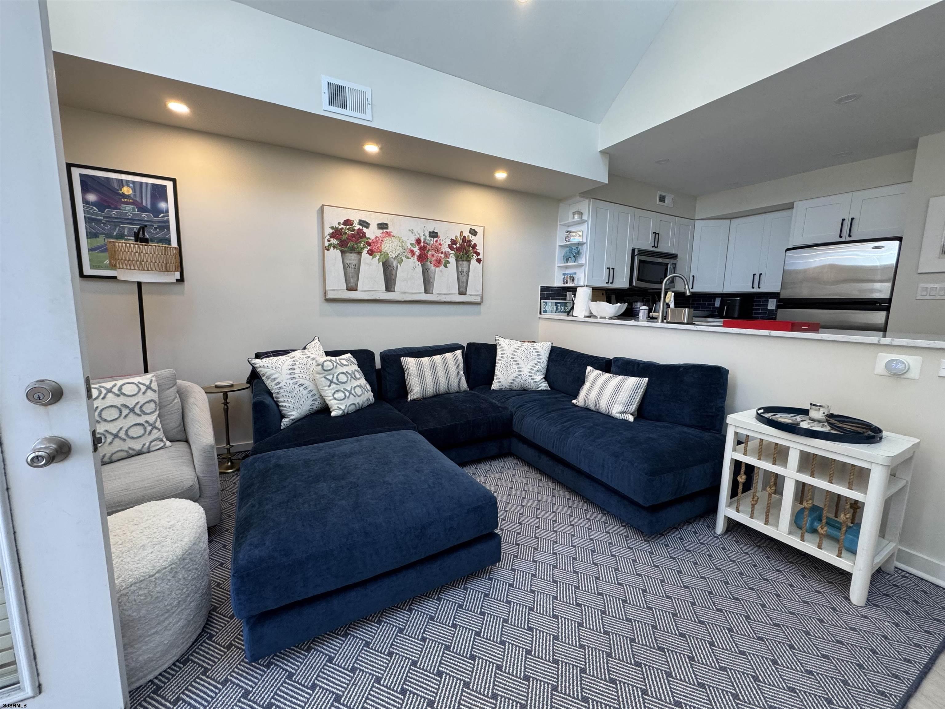 9101 Atlantic Avenue, Unit 202 Margate City, NJ 08402 - Photo 6 of 26 a living room with furniture and a flat screen tv