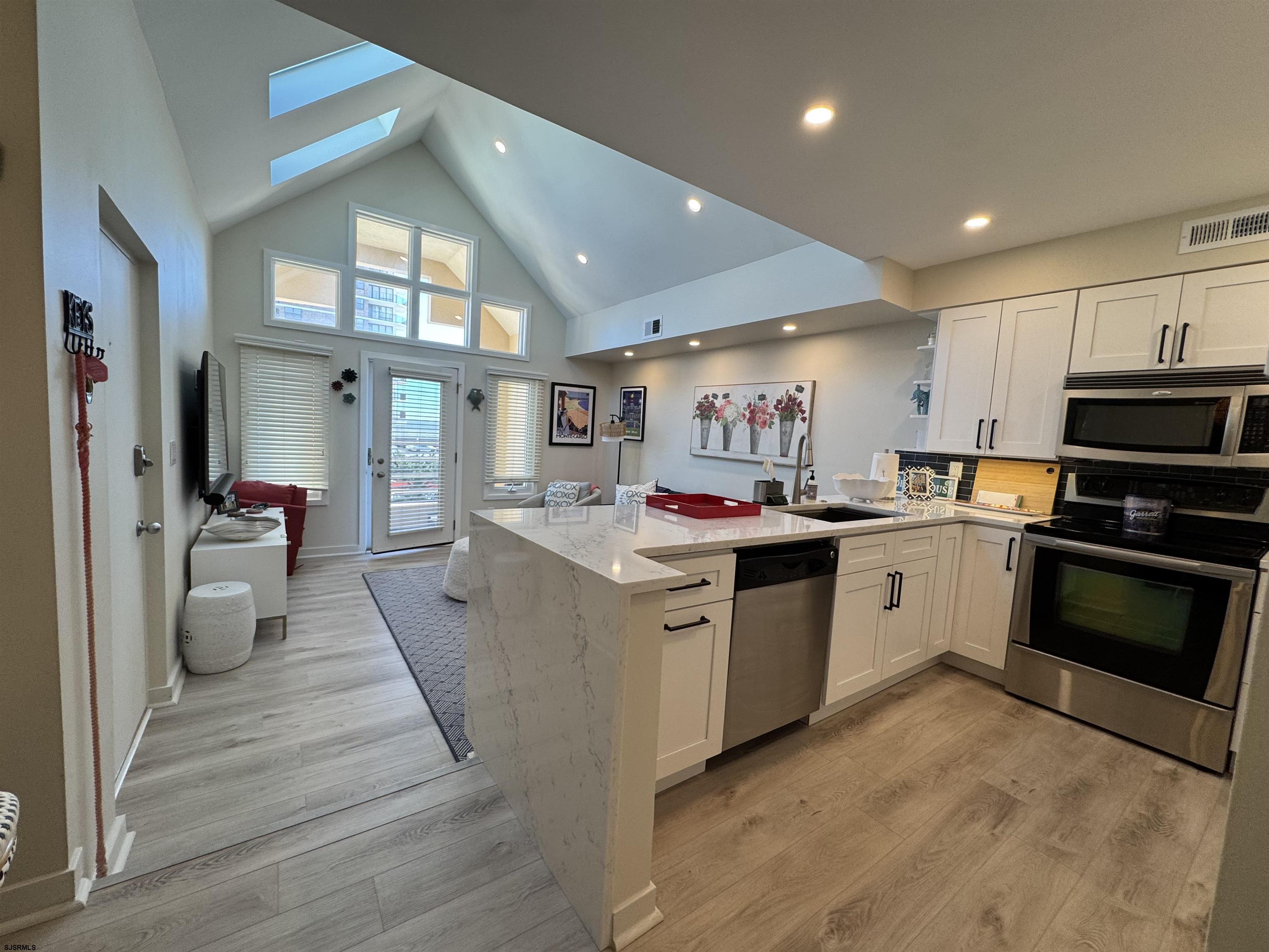 9101 Atlantic Avenue, Unit 202 Margate City, NJ 08402 - Photo 9 of 26 a kitchen with stove and cabinets