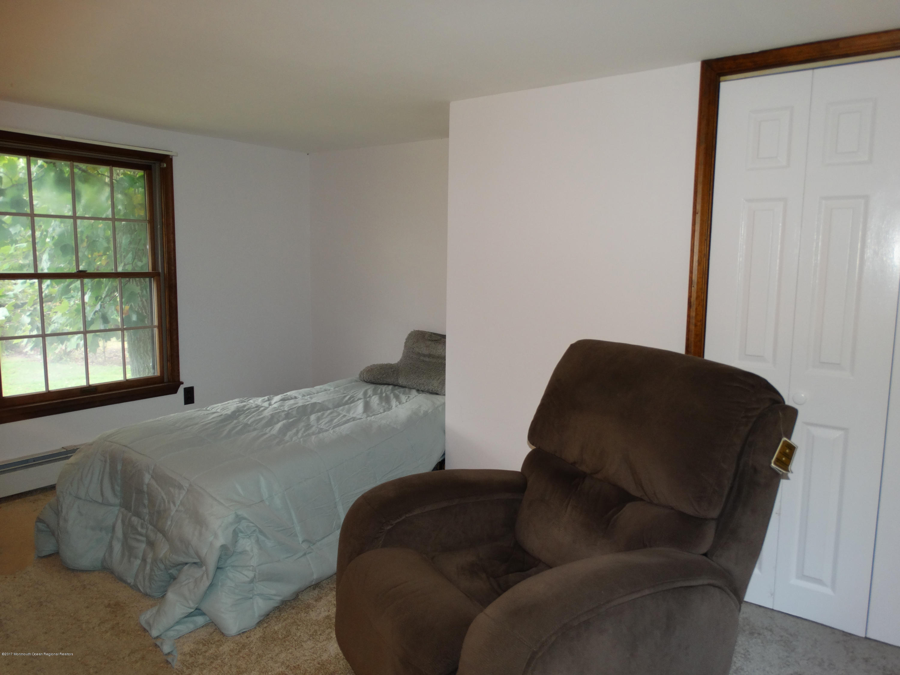 850 Adelphia Road Freehold, NJ 07728 - Photo 15 of 25 a bed sitting in a bedroom next to a window