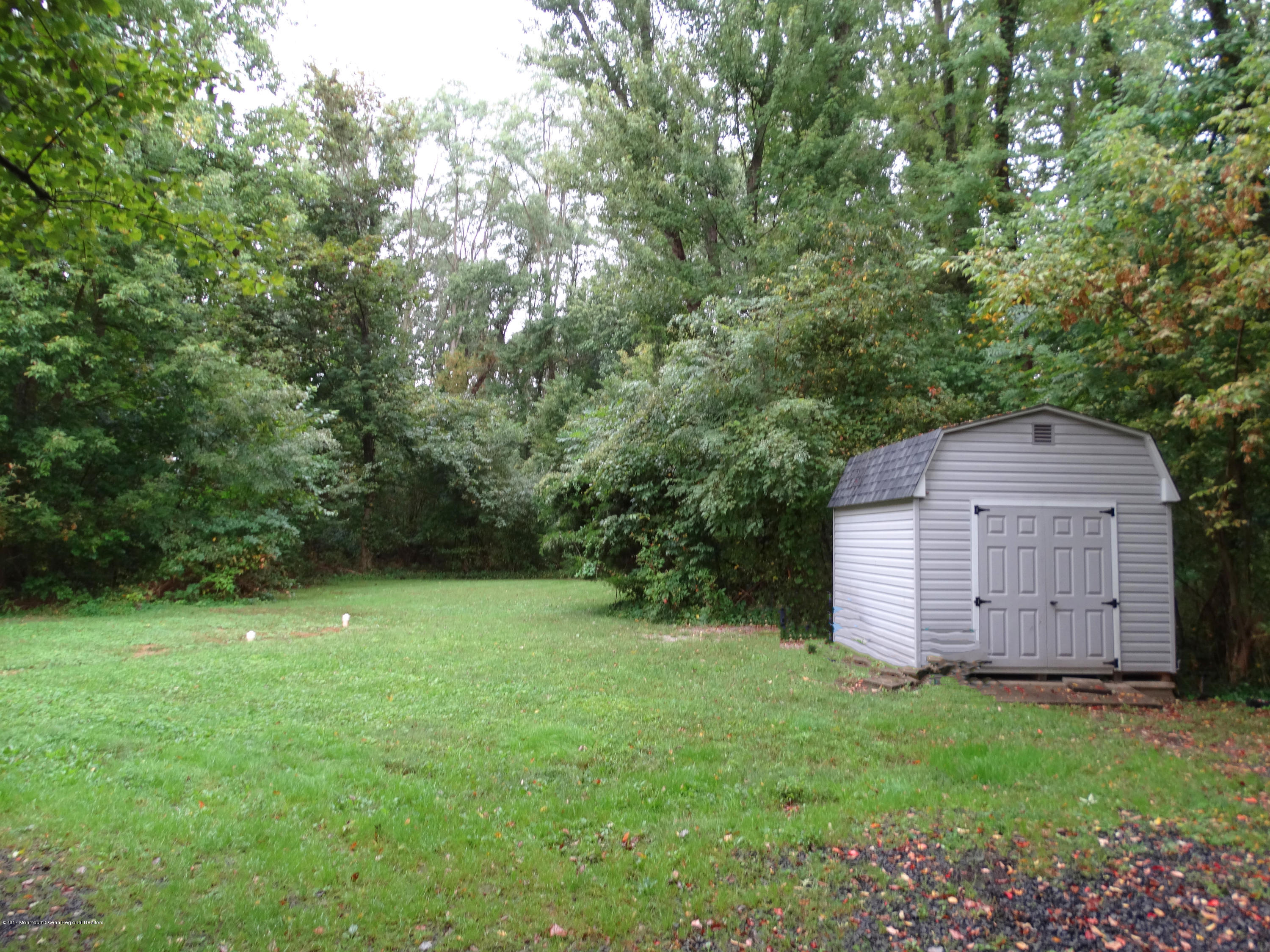 850 Adelphia Road Freehold, NJ 07728 - Photo 22 of 25 a view of a backyard with barn