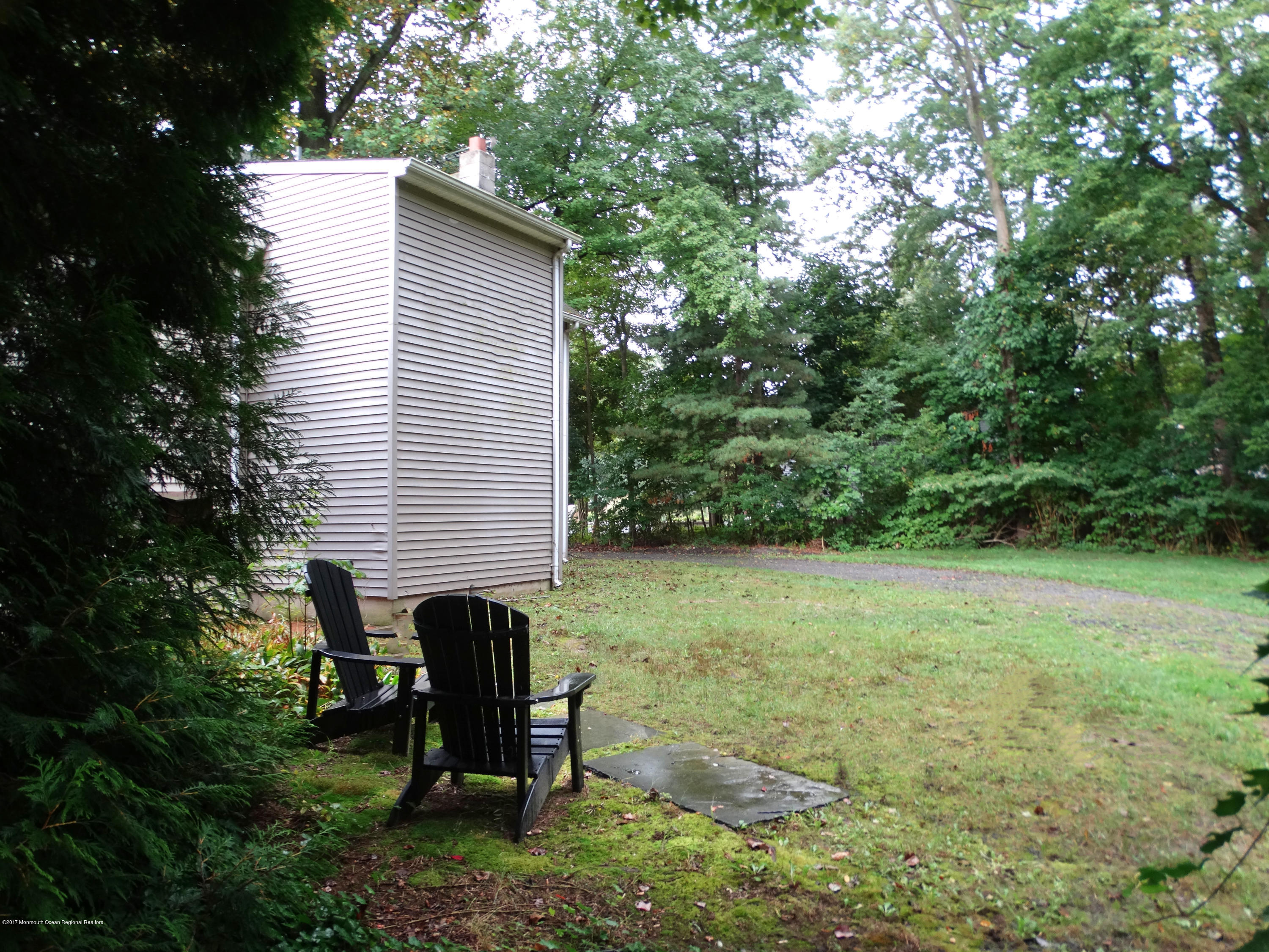 850 Adelphia Road Freehold, NJ 07728 - Photo 24 of 25 a backyard of a house with table and chairs