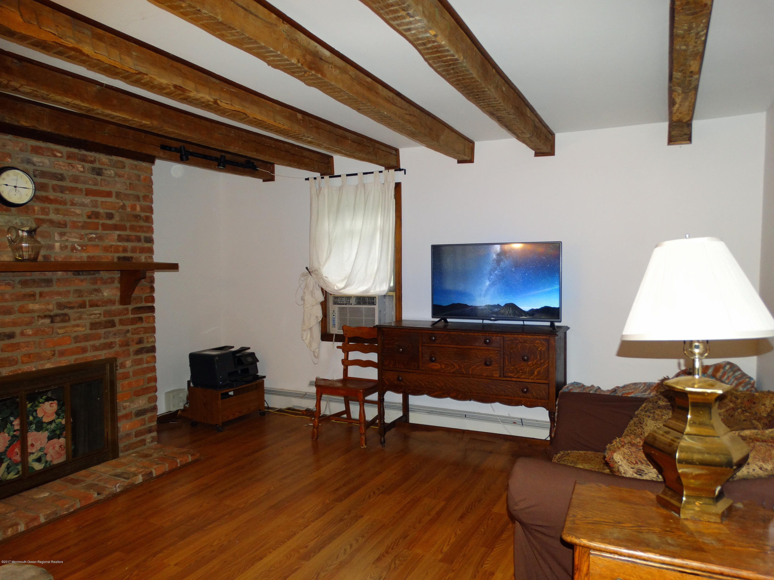 850 Adelphia Road Freehold, NJ 07728 - Photo 4 of 25 a living room with furniture and a fireplace