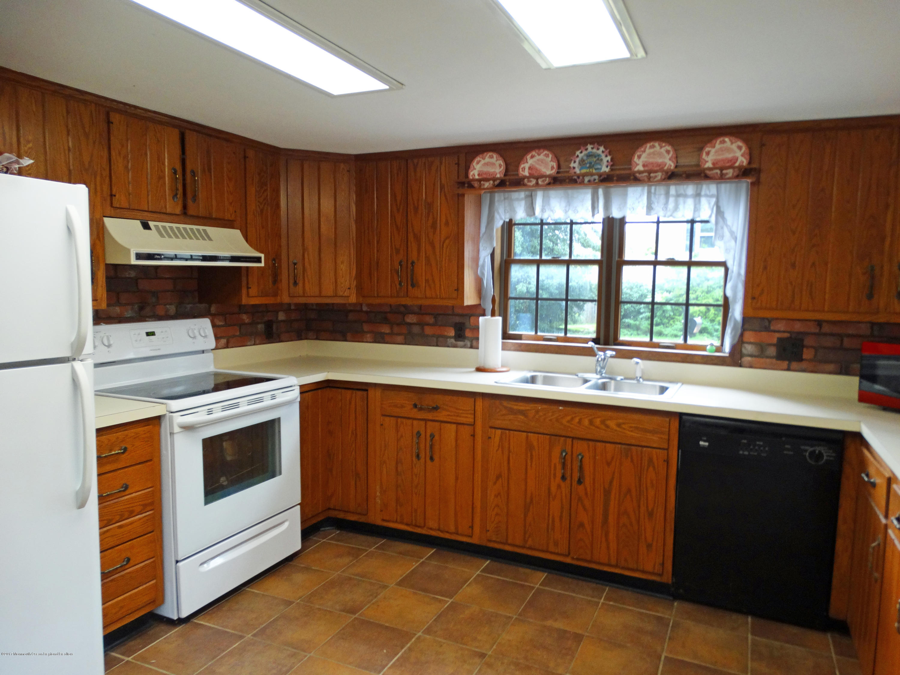 850 Adelphia Road Freehold, NJ 07728 - Photo 8 of 25 a kitchen with stainless steel appliances granite countertop a stove a sink and a microwave
