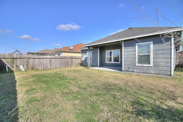 a view of a house with a backyard and porch