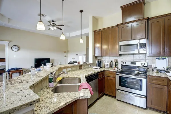 a kitchen with a sink stove and microwave