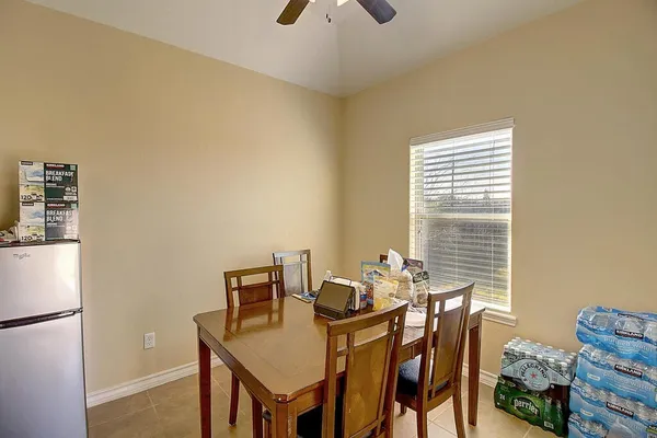a view of a dining room with furniture and a window