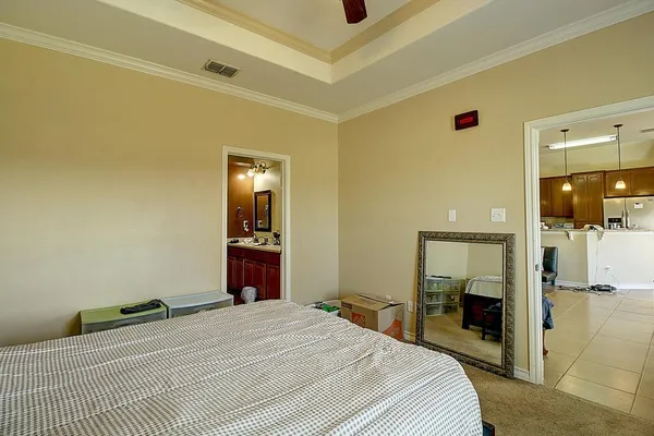 a bedroom with a bed and a mirror