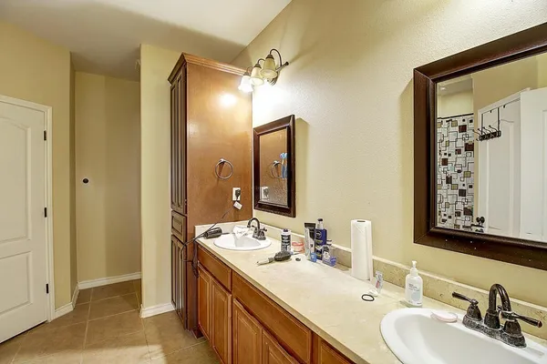 a bathroom with a double vanity sink mirror and double