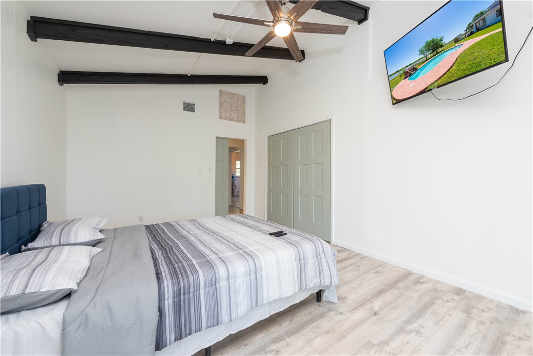 132 Zenna Drive Mathis, TX 78368 - Photo 11 of 40 a bedroom with a bed and a painting on the wall