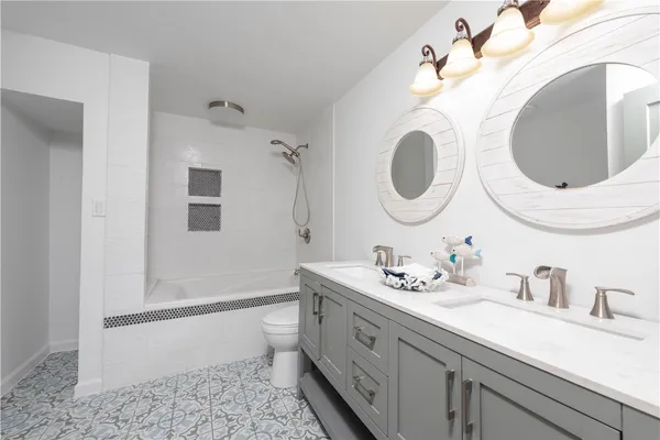 a bathroom with a double vanity sink and a mirror