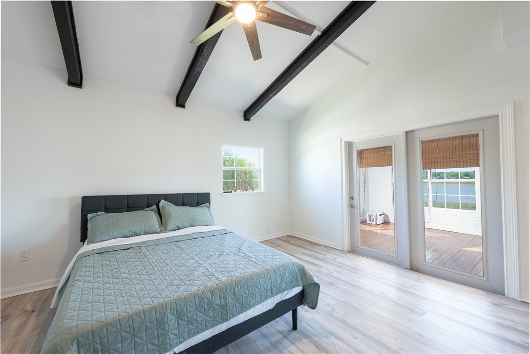 132 Zenna Drive Mathis, TX 78368 - Photo 14 of 40 a bedroom with a bed and wooden floor