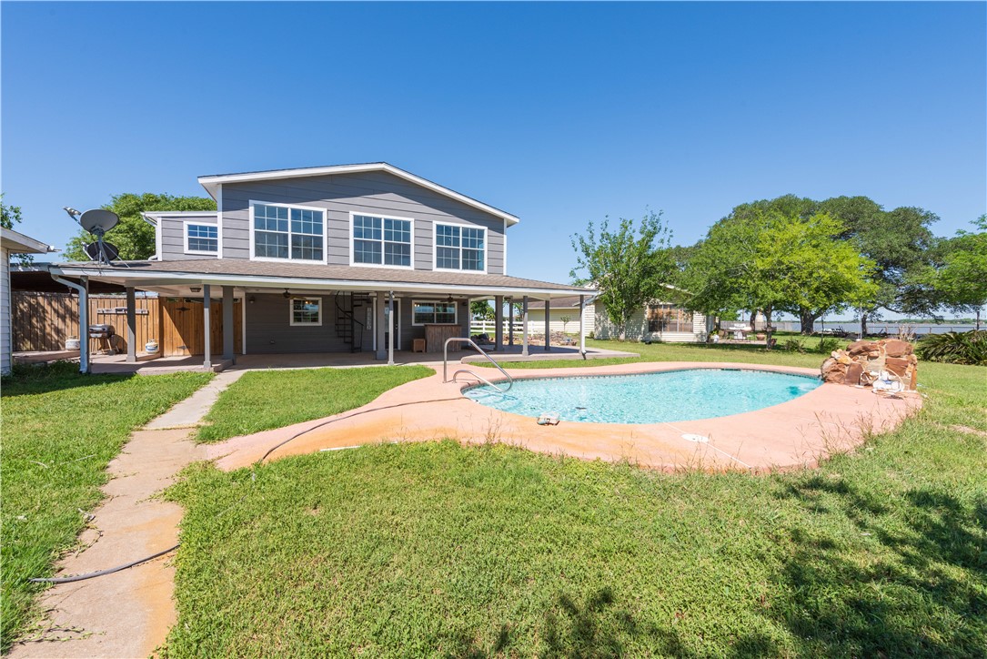 132 Zenna Drive Mathis, TX 78368 - Photo 2 of 40 a view of an house with swimming pool and yard
