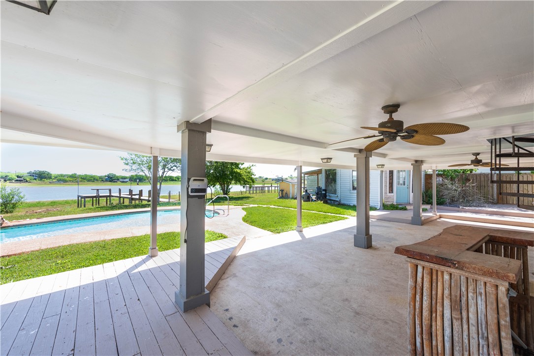 132 Zenna Drive Mathis, TX 78368 - Photo 30 of 40 a view of a swimming pool with a table and chairs under an umbrella