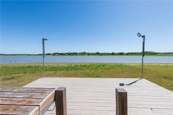 a view of a lake with a wooden fence