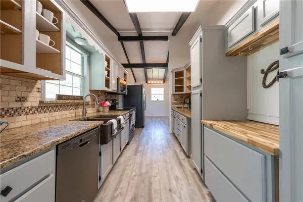 a kitchen with stainless steel appliances granite countertop a stove and a refrigerator