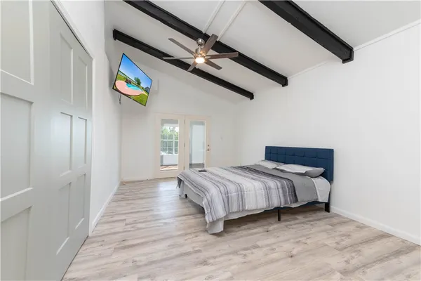a bedroom with a bed and a window