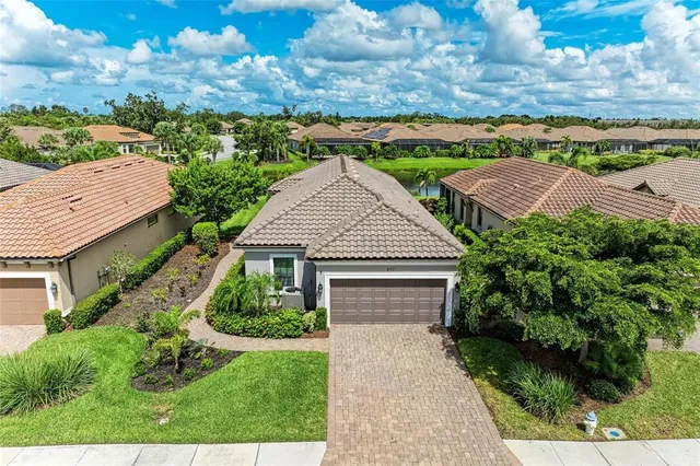 an aerial view of residential house with outdoor space and lake view