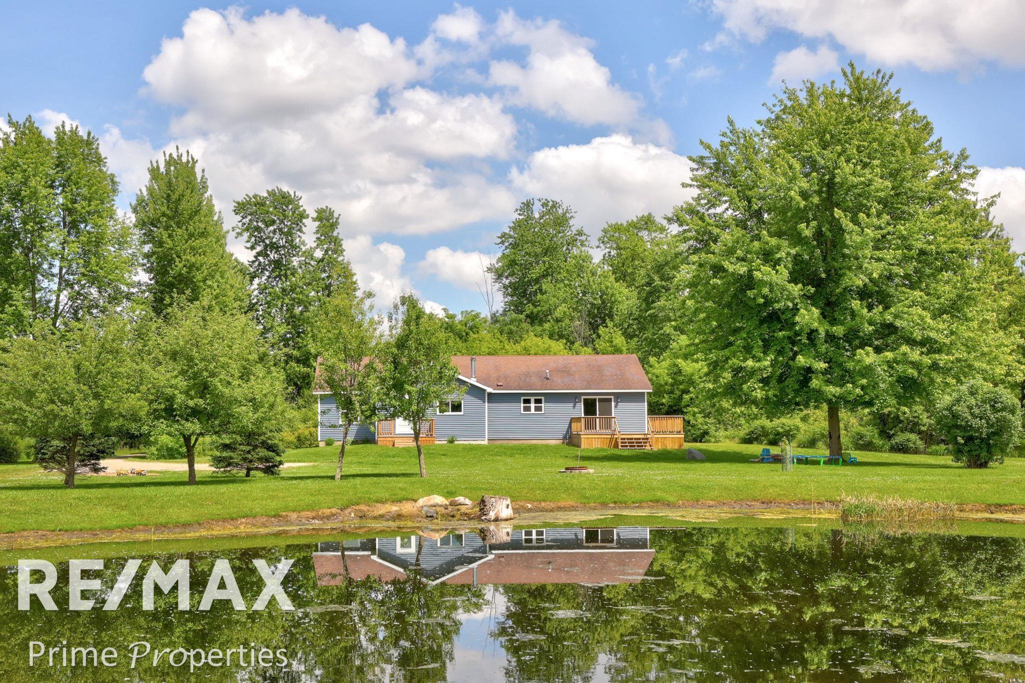 2285 North Cemetery Road Deford, MI 48729 - Photo 1 of 46 Escape to tranquility in this charming countryside home, perfectly nestled amid lush greenery and a serene pond. Enjoy peaceful mornings and evenings on the spacious deck, surrounded by nature's beaut