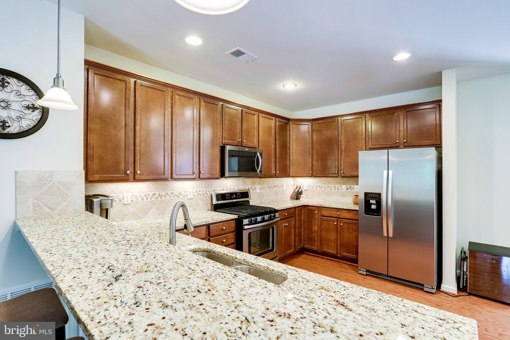 44320 McHenry Square Ashburn, VA 20147 - Photo 14 of 55 Beautiful granite countertops and pendant lights