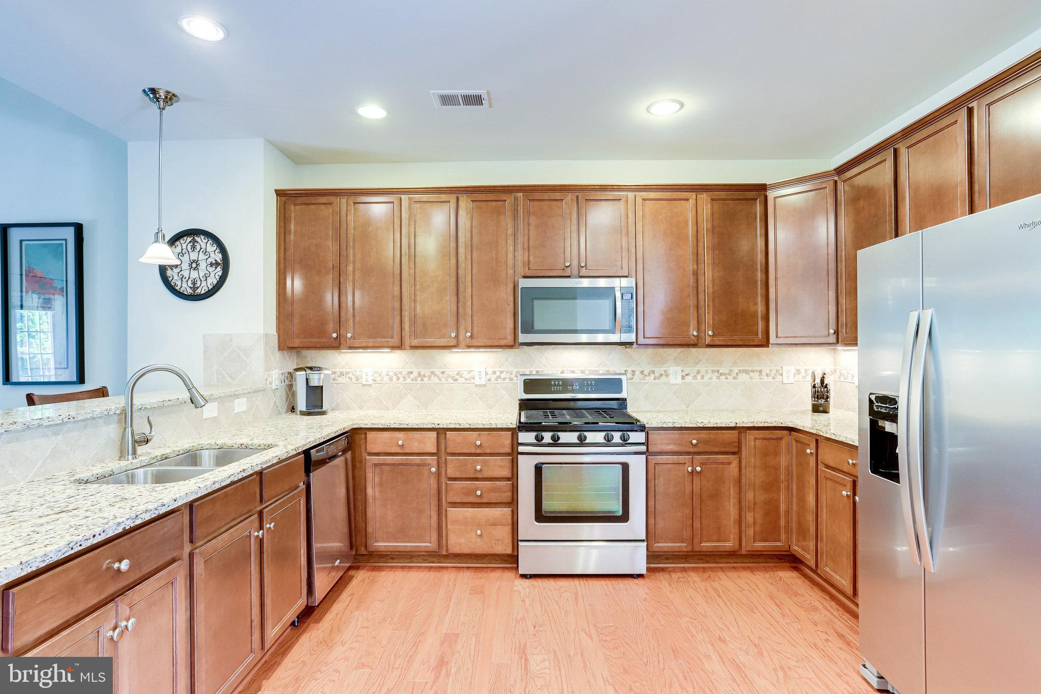 44320 McHenry Square Ashburn, VA 20147 - Photo 9 of 55 Under cabinet lighting and ceramic tile backsplash