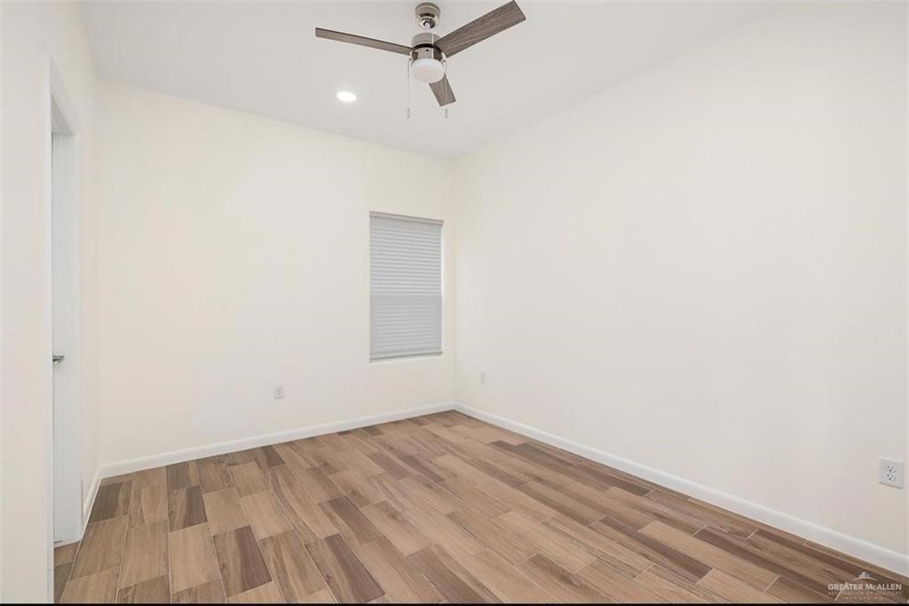 2913 East Israel Avenue Alton, TX 78573 - Photo 11 of 23 a view of a room with wooden floor and fan