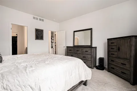 a bedroom with a bed and dresser