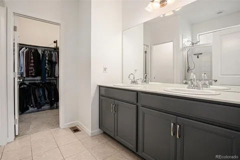 a bathroom with a double vanity sink and a mirror