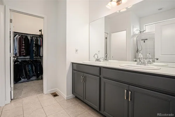 a bathroom with a double vanity sink and a mirror