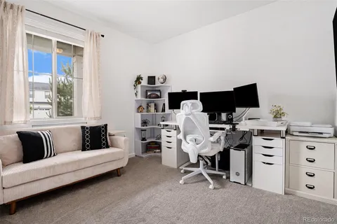a view of a livingroom with workspace and a couch