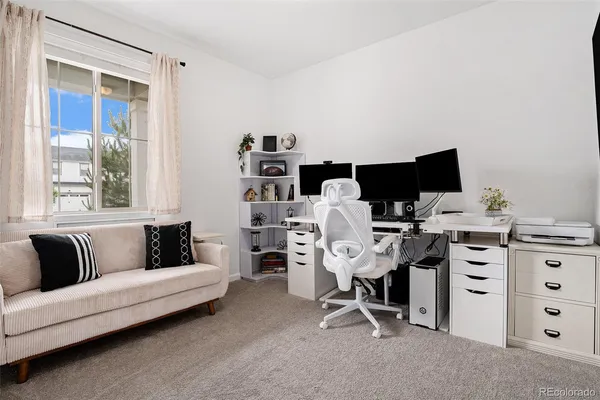 a view of a livingroom with workspace and a couch