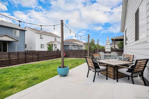 a view of a patio with chairs and a potted plants