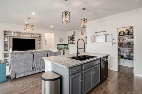 a kitchen with a stove a sink and a refrigerator
