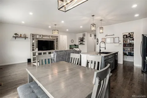 an open kitchen with sink and stainless steel appliances