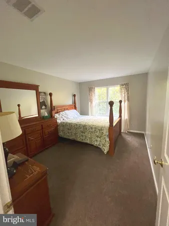 a bathroom with a double vanity sink mirror and toilet